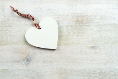 A wooden heart on a wooden backgroundの写真素材