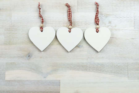 Three wooden hearts on wooden background, copy spaceの写真素材