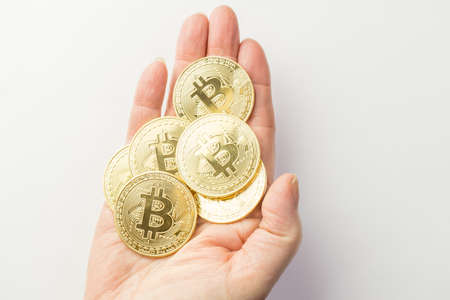 Golden bitcoins holding in handの写真素材