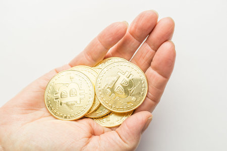 Golden bitcoins holding in hand