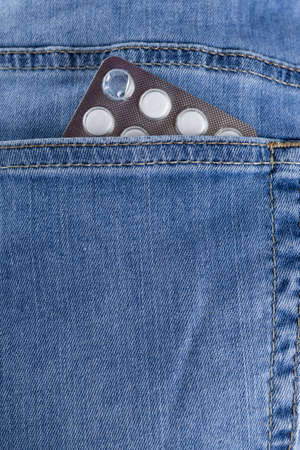 Jeans pocket with a blister of medicineの写真素材