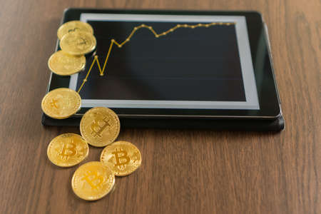 Tablet with golden bitcoinsの写真素材