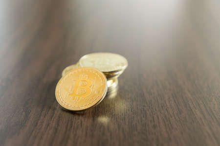 Golden bitcoins on wooden backgroundの写真素材