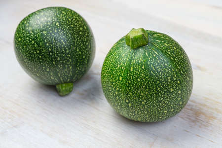 Two round zucchini on wooden backgroundの写真素材
