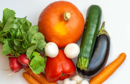 Pumpkin, eggplant, carrots, mushroom, pepper, radish and courgette on white backgroundの写真素材