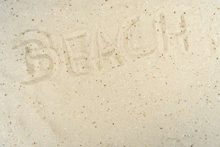 The word beach written in the sand of a beachの写真素材