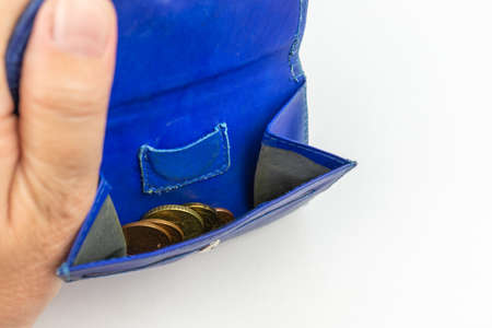 Woman opens wallet in which only a few cents areの写真素材