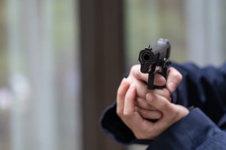 Woman holds a pistol in her hand