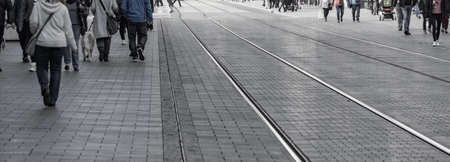 Banner in a downtown with many people and tram railsの写真素材