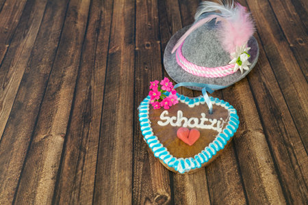 Bavarian hat with a heart of gingerbread and the German word for sweetheartの写真素材
