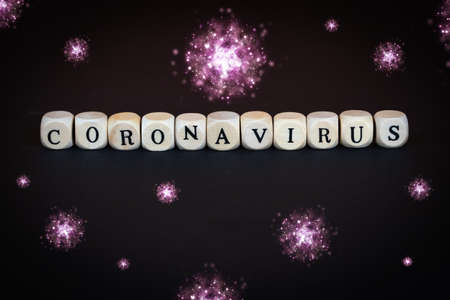 The word coronavirus in wooden cubes with many corona virusesの写真素材