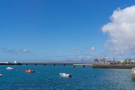 Many small fishing boats and row boats in the waterの写真素材