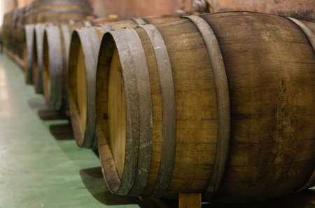 old wooden wine barrels in a wine pressの写真素材