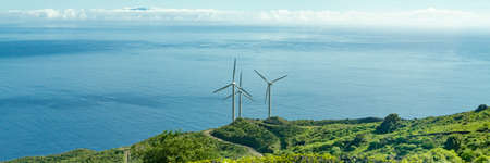 Three wind turbines on the coast of the Canary Island of La Palma, Spain, in the background the Atlantic Oceanの写真素材