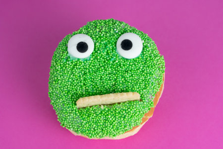 Delicious cake with funny face, pink backgroundの写真素材