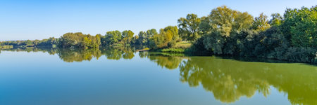 Beautiful panorama of the lake landscape on a summer day in the Fuldaaue in Kassel, Germany