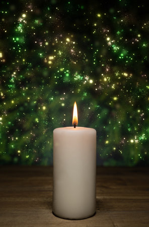 A white burning candle on a wooden table, Christmas lights background and copy spaceの写真素材