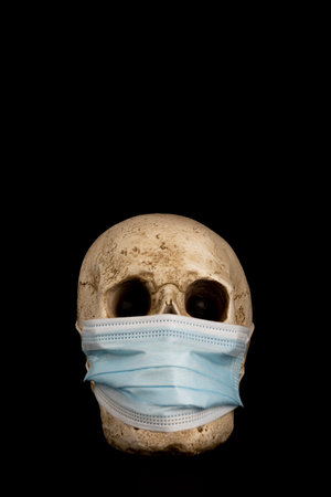 Skull with respirator on black background, copy space