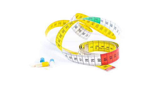 Various tablets with a tape measure isolated on white and copy spaceの写真素材
