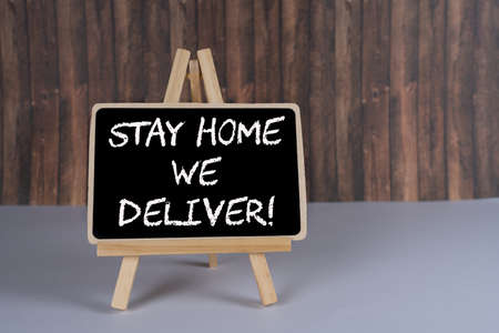 Black board with the inscription Stay home we deliverの写真素材