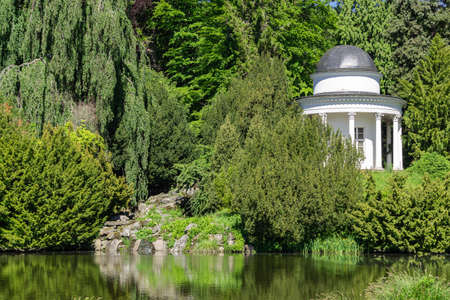 Small white temple in a park in front of a pondのeditorial素材