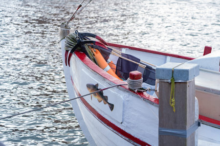 Bow of a fishing boat firmly tied with a rope