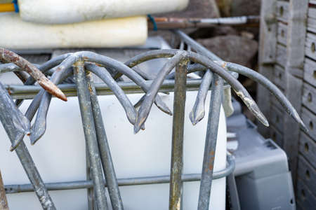 Lots of small metal anchors hung on a railingの写真素材