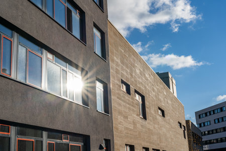 Facade of a modern building with sun rays in the windowの写真素材