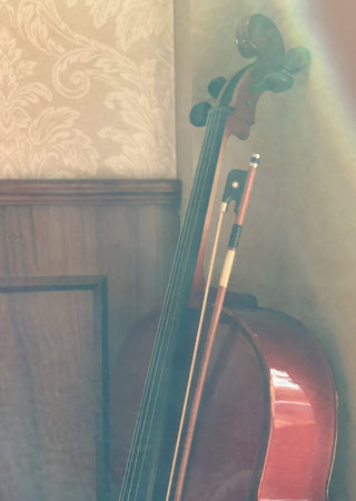 A violin in the mist of the morning sun falling through the windowの写真素材
