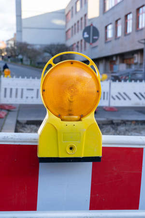 Red warning lamp at a construction site during the dayの写真素材