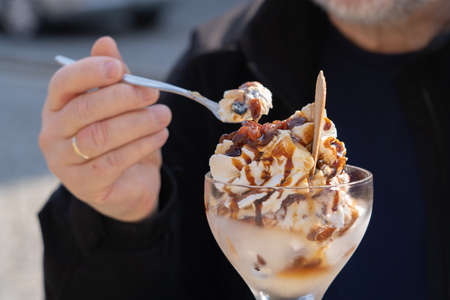 Man eats a delicious sundae Malagaの写真素材