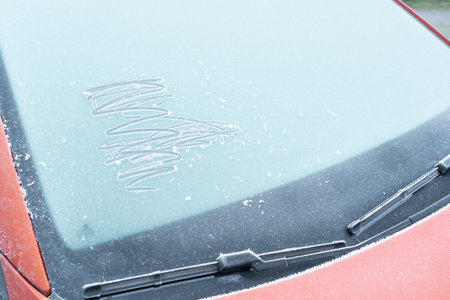 Red car with a frozen windowの写真素材