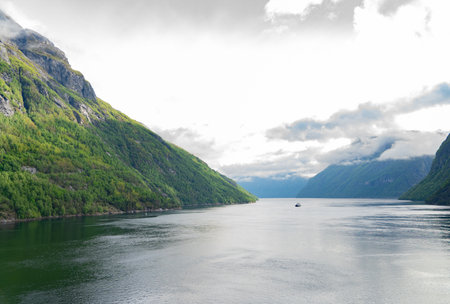 Beautiful fjord landscape with a ship at Hellesylt in Norwayの写真素材