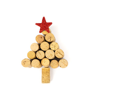 Fir tree made from corks from wine bottles, with a red star on top, white background with copy spaceの写真素材