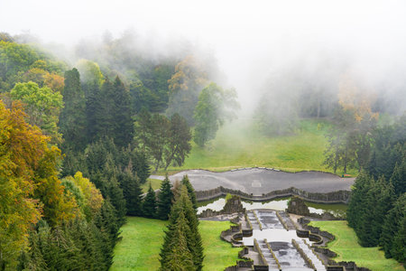 The stairs with its water basins of the famous water features in the mist-shrouded mountain park in...