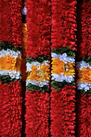 Brightly coloured garlands of red, white, green and orange, used as traditional decorations during the Hindu festival of Deepavali.の写真素材
