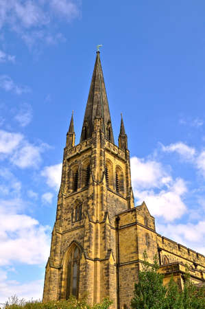 Traditional English church with a conical church spire and rectangular belfry, taken on a beatiful summers day.の写真素材