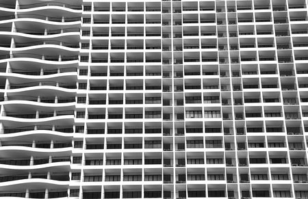 Contemporary modern apartment building with contrasting curved and straight horizontal lines.
