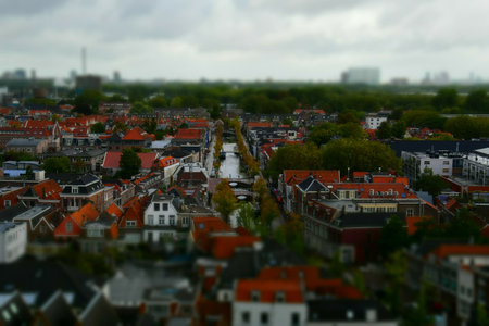 An aerial view of streets and canals in Delft a popular tourist destination in the Netherlands. It is full of typical traditional dutch houses and a canal network.の写真素材