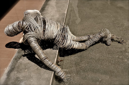 Human figurine created out of coils of industrial guage thick steel wire.の写真素材