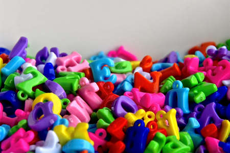 A side perspective view of colourful plastic alphabet beads. の写真素材