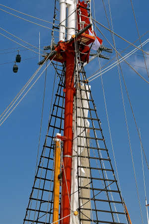 A detailed view of the ropes, ladders and rigging surrounding the mast of a traditional sailing yacht.の写真素材