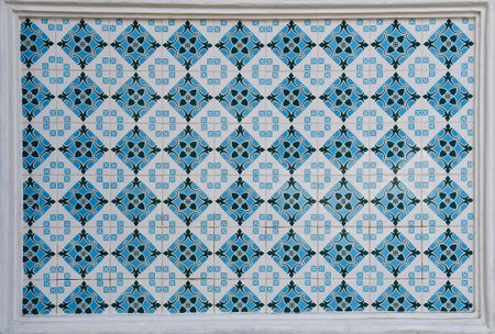 Blue and white geometric patterned tile mosaic, typical of those found on the facades of traditional...