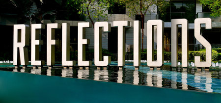 A REFLECTIONS sign in a pool.
