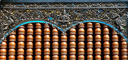 A close up view of terracotta urns in a column formation to create an open window barrier. This is...