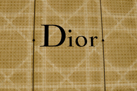 Illuminated shop frontage sign of the luxury designer Dior store.
