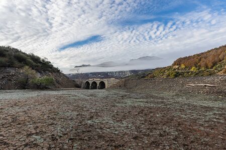 Photo of old bridge in a frosty morning, in general under the waters of the Riaño reservoir in Leon (Spain).の写真素材