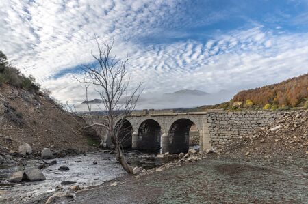 Photo of old bridge in a frosty morning, in general under the waters of the Riaño reservoir in Leon (Spain).の写真素材