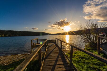 Views during the beautiful sunset on the dock for fishing of the Selga de Ordas reservoir in Leon, Spainの写真素材