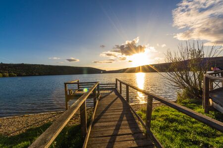 Views during the beautiful sunset on the dock for fishing of the Selga de Ordas reservoir in Leon, Spainの写真素材